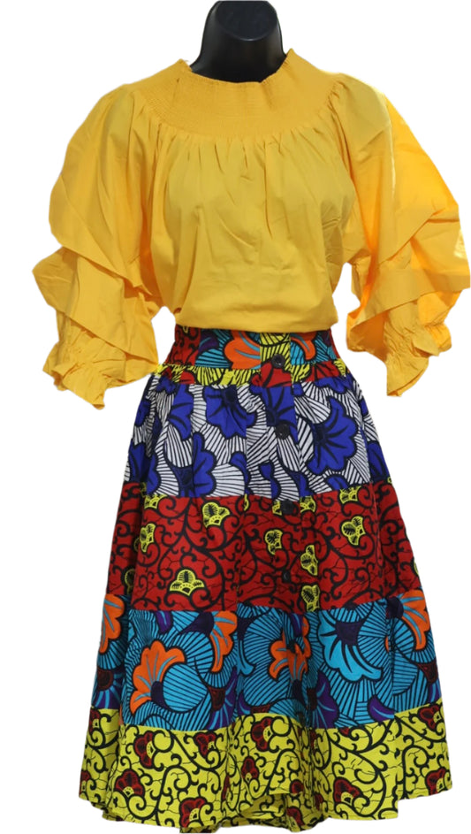 Mannequin wearing a yellow top and colorful patterned skirt on a white background