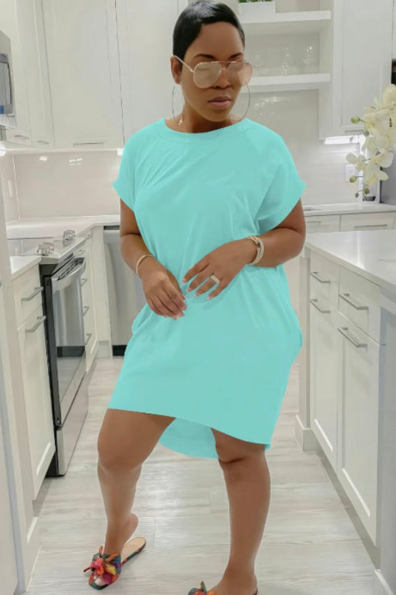 Woman wearing a light blue dress in a kitchen setting