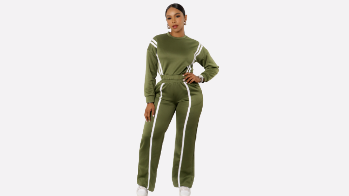 Woman wearing a green tracksuit with white stripes on a white background
