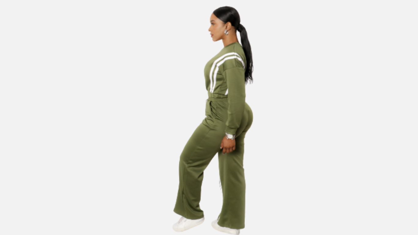 Person wearing a green tracksuit with white stripes on a white background