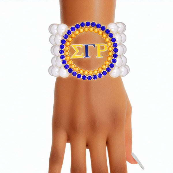 Women’s blue and gold Sigma Gamma Rho pearl bracelet with five strands of white pearls, gold beads, and blue rhinestone accents, stretch-to-fit design.