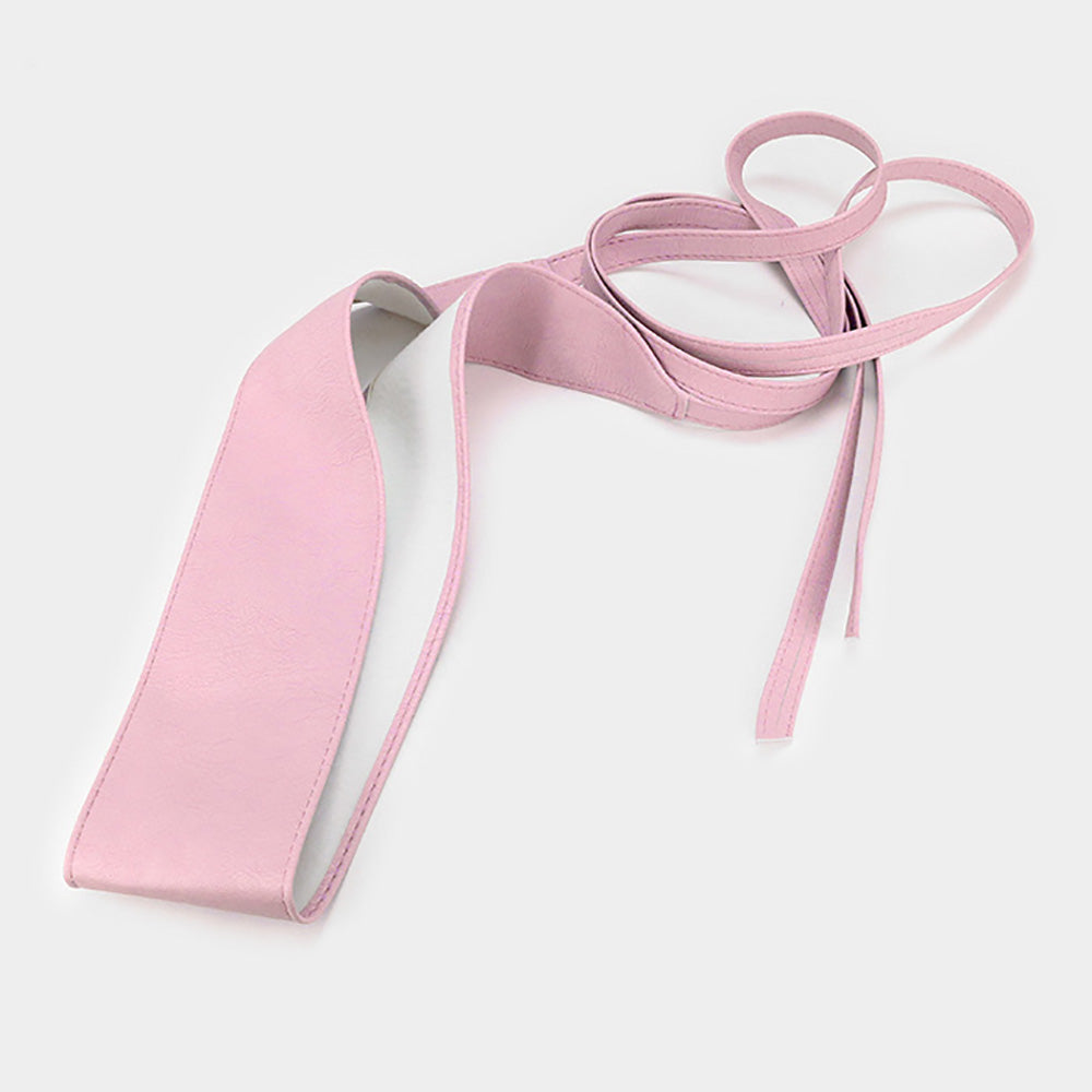 Light pink faux leather corset waist belt displayed on a white background, featuring a wide wrap band and long adjustable tie straps.