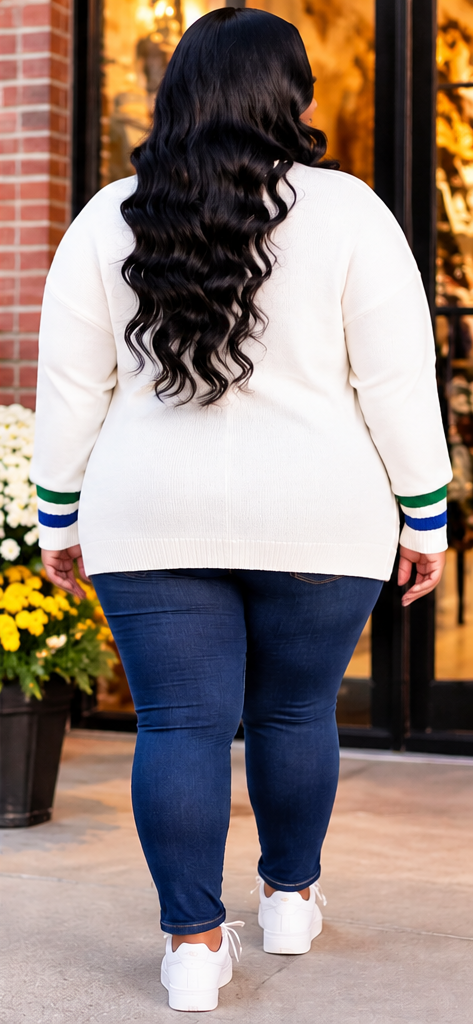 Back view of an ivory women's varsity cardigan with a plain back, blue and green striped sleeve cuffs, and a relaxed fit.