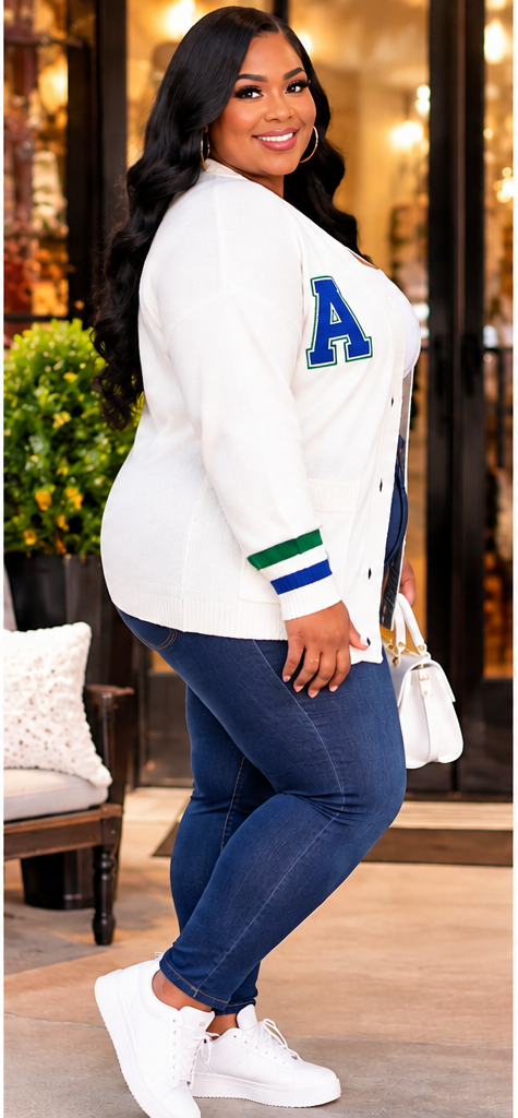 Side view of an ivory women's varsity cardigan featuring blue and green striped sleeve cuffs, collegiate letter patch, and a relaxed fit.