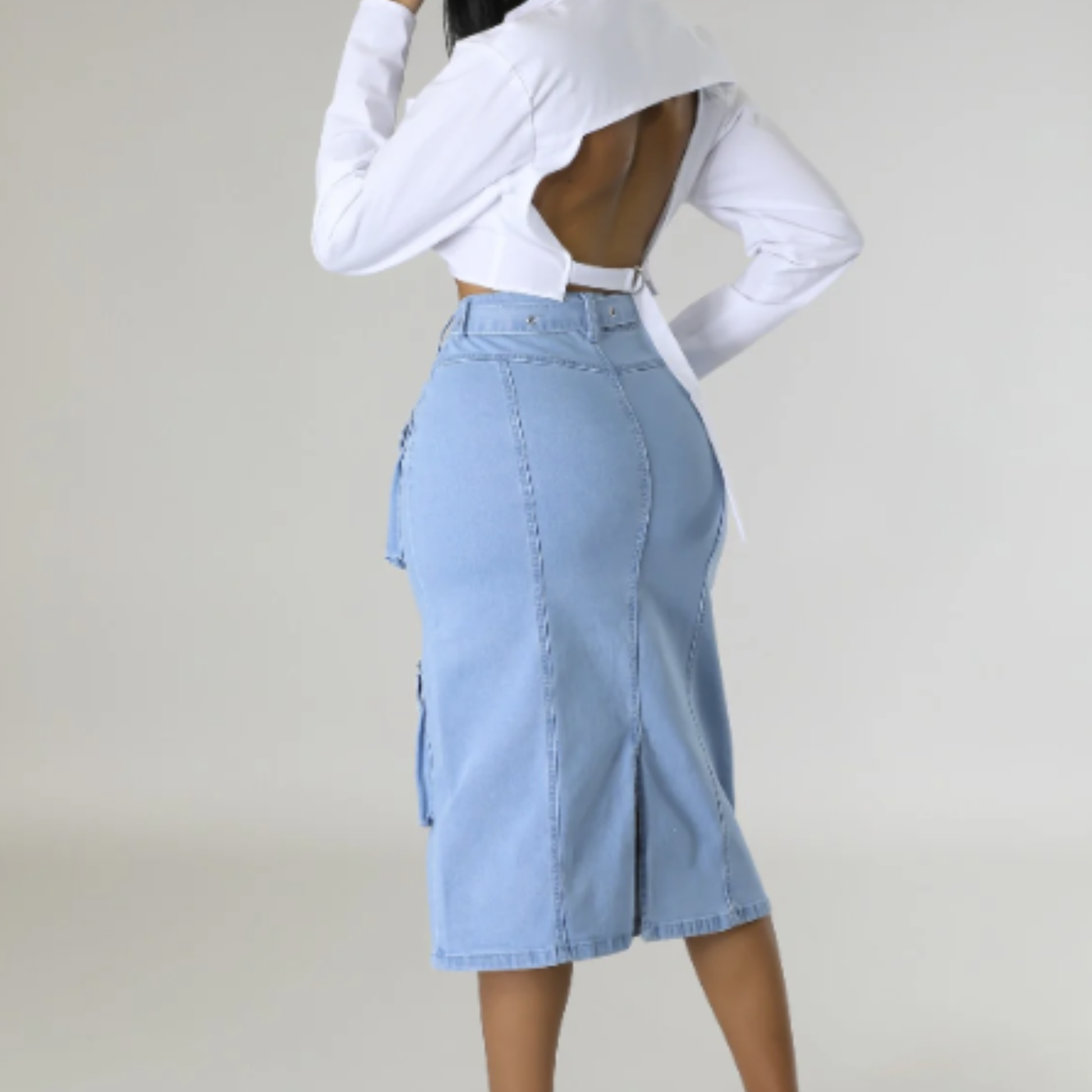 Light blue denim skirt worn by a person on a plain background